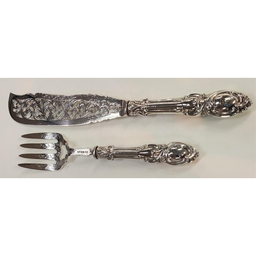 724 - A hallmarked silver pair of fish servers, ornately pierced and embossed, Birmingham 1853