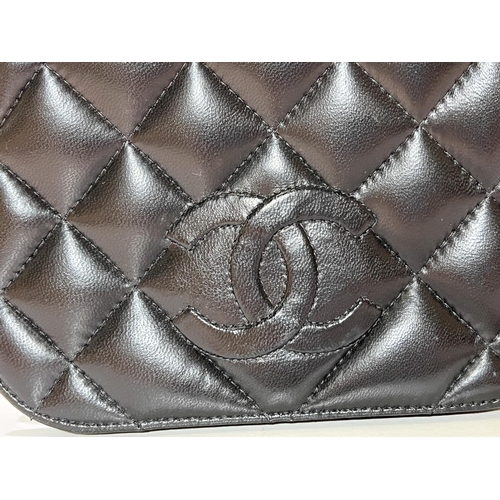 166 - A black soft lamb leather cross body double flap bag with embossed CC logos to front and back flaps ... 