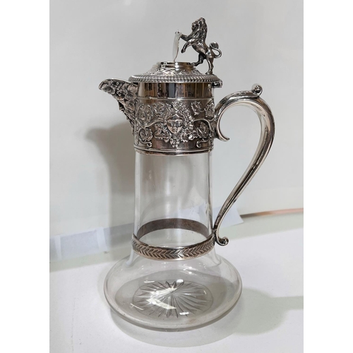 658 - A Victorian cut glass claret jug with hallmarked silver mount and handle, with relief decoration of ... 