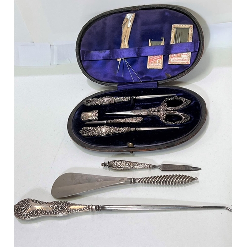 659A - A cased hallmarked silver part needlework set; button hook etc