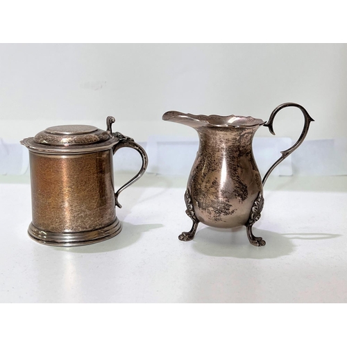 697 - A Georgian style silver cream jug, J.G. Ltd, Birmingham 1969; a mustard pot, Sheffield 1936 (no line... 