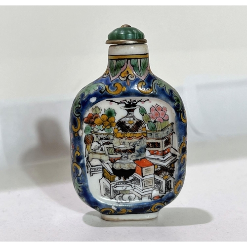 505 - A Chinese ceramic snuff bottle decorated with vases etc to one side, text to the other , 6cm