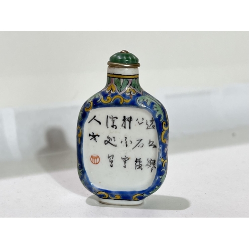 505 - A Chinese ceramic snuff bottle decorated with vases etc to one side, text to the other , 6cm