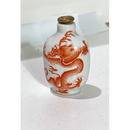 507 - A Chinese ceramic snuff bottle with orange dragon to one side and blue dragon to the other