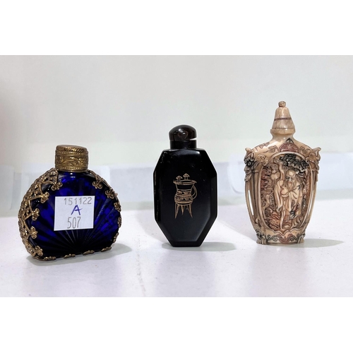 507A - A Chinese horn and bone snuff bottle with traditional scene, a simulated ivory snuff bottle and a bl... 