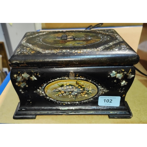 102 - A 19th century black lacquered tea caddy with inlaid abalone and mother-of-pearl decoration