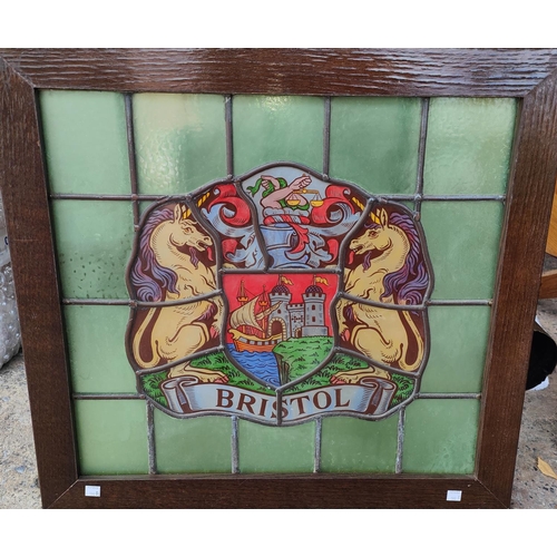 190B - An oak framed stained leaded glass crest of Bristol 49 x 53cm