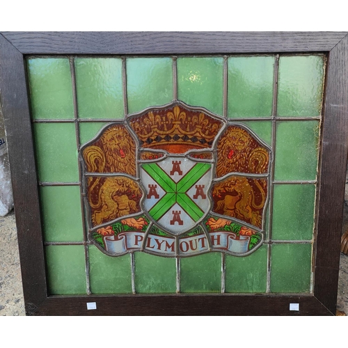 190D - An oak framed stained leaded glass crest of Plymouth 50 x 57cm