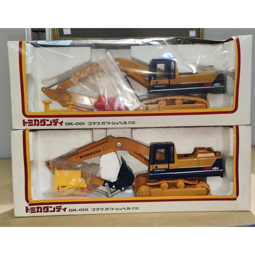 252 - Two boxed Komatsu Tomica Dandy 1/43 scale DK-001 PC200 diecast digger (one plastic front missing)