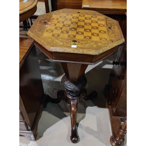 983 - A Victorian octagonal inlaid x marquetry work games/work table with fitted interior, well, and carve... 