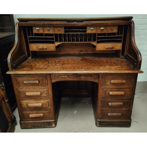 996 - A 1930's large serpentine roll top desk, with fully fitted interior, pillar drawers to either side a... 