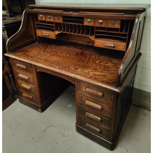 996 - A 1930's large serpentine roll top desk, with fully fitted interior, pillar drawers to either side a... 