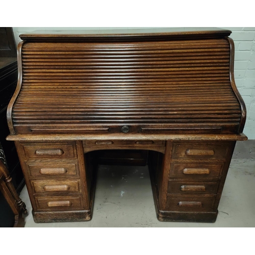 996 - A 1930's large serpentine roll top desk, with fully fitted interior, pillar drawers to either side a... 