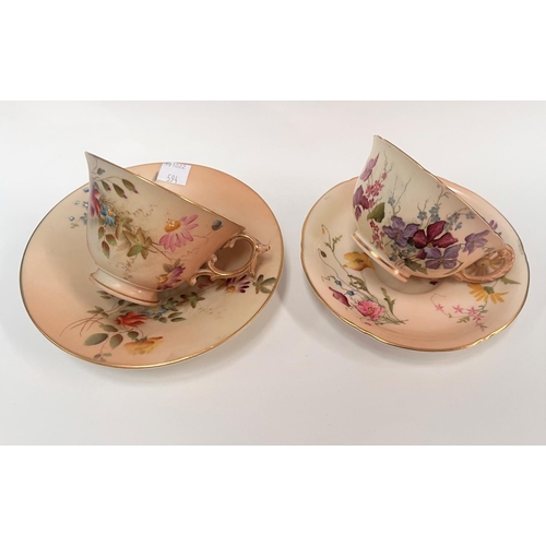 594 - Two Royal Worcester cabinet cups and saucers decorated in polychrome against a peach blush ground