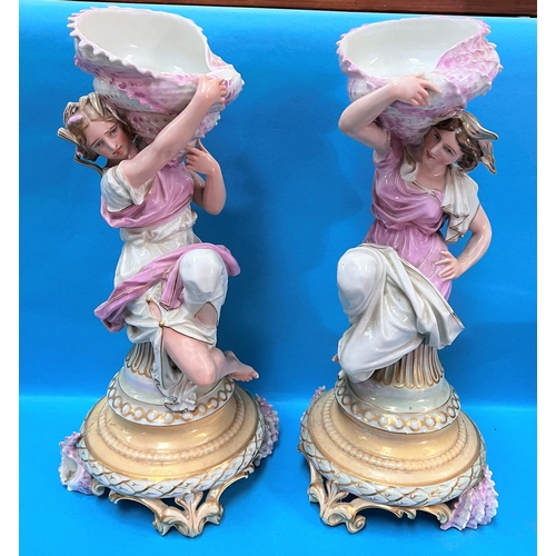 626 - A pair of 19th century French porcelain female figures carrying shells on their shoulders, by Gillet... 