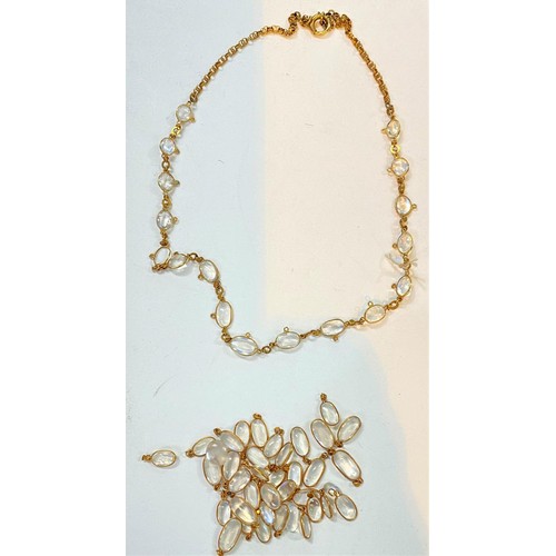 763 - A yellow metal necklace formed from overlapping circular links set with oval moonstones, with approx... 