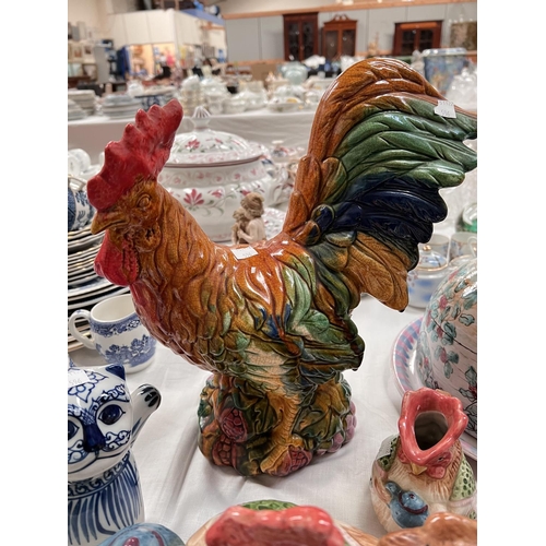 596 - A majolica cockerel; other pottery animals; a large cheese dish and cover