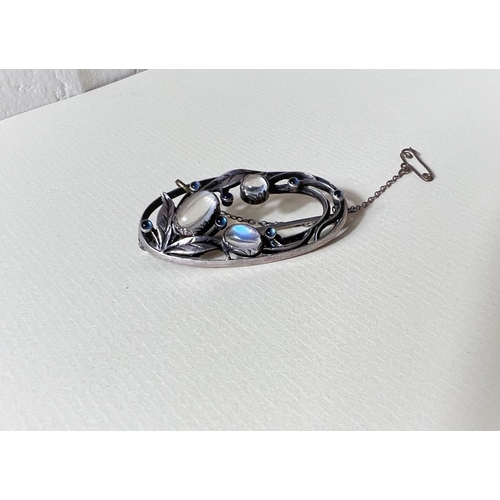 763A - An elongated pierced oval Art Nouveau style white metal brooch formed from leaves / flower set with ... 