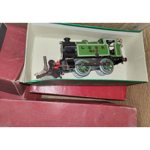 198 - A Hornby train boxed tin plate clockwork 'O' gauge set loco carriages etc, track, signals and variou... 