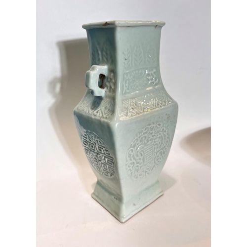 443 - A Chinese celadon squared vase with relief decoration of geometric design, two hooped handles, seal ... 