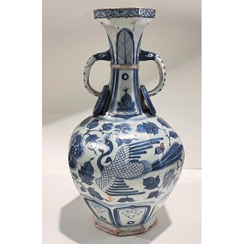 463 - A Chinese blue and white vase in the Yuan manner decorated with birds and double handle, ht. 34cm