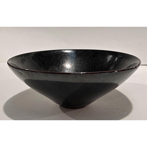 468A - A Chinese dark glazed bowl with small foot, leaf decoration in the glaze, 15cm dia