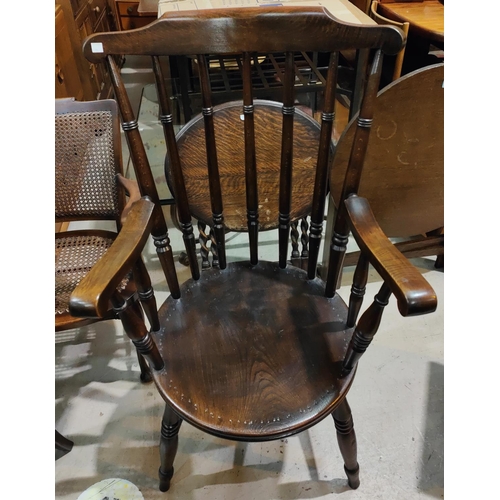 984 - A 19th century stained wood ladder back rocking armchair; a stained wood spindle back armchair.