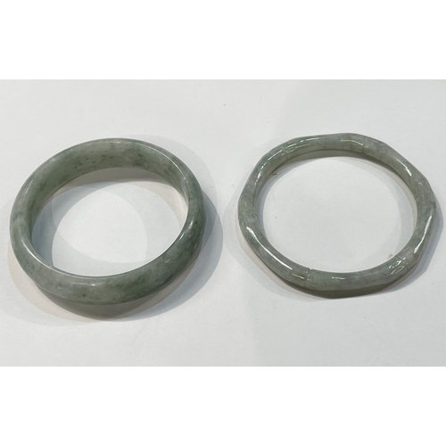 460 - Two light Jade coloured bangles, one hexagonal and one hoop shaped.