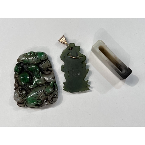 498 - Three Chinese jade coloured hard stone items: One carved belt loop and two pendants, one mounted in ... 