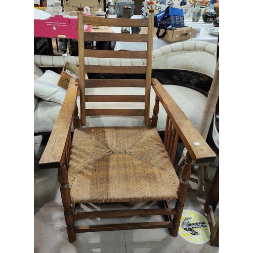 973 - A mid 20th century ladderback rush seat adjustable armchair, in the manner of Neville Neal.