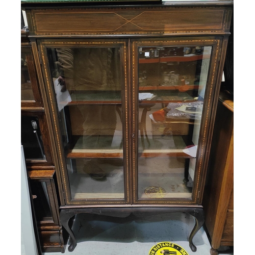 982 - An Edwardian Sheraton inlaid mahogany china cabinet enclosed by two doors.