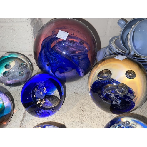 651A - Eight glass paperweights, mostly Caithness, 2 larger size