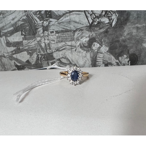 662 - An 18 carat hallmarked gold cluster ring set oval sapphire surrounded by 12 diamonds, 4.6gm