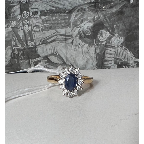 662 - An 18 carat hallmarked gold cluster ring set oval sapphire surrounded by 12 diamonds, 4.6gm