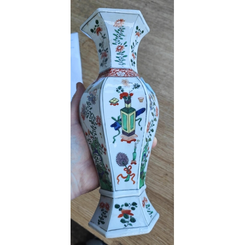 470 - A Chinese famille vert hexagonal shaped baluster vase decorated with vases, flowers etc, ht. 28cm