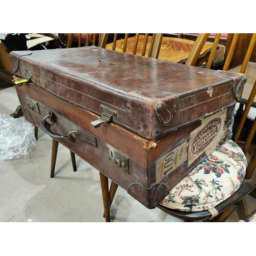 274 - A vintage leather suitcase, bears initials 'J.E.M.', with stickers; a selection of handbags; etc.