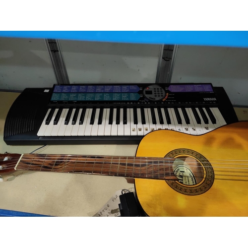 18 - An acoustic 'Angelica' guitar, nylon strung, sold by Boosey & Hawkes; a Yamaha PSR-73 keyboard