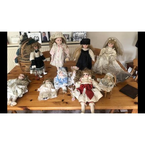 25 - A collection of 10 modern china head dolls in Victorian dress