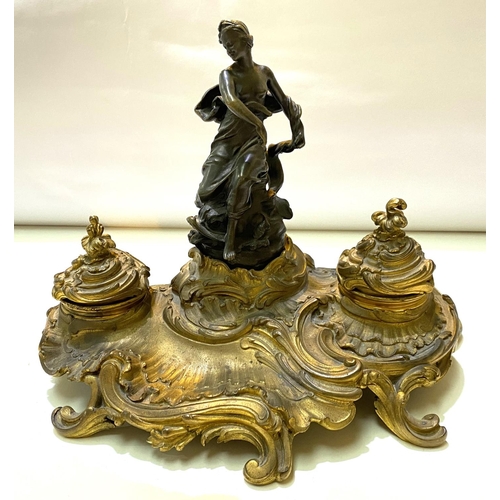 100 - A 19th century French brass and bronze inkstand in the rococo manner with semi clad female figure, 2... 