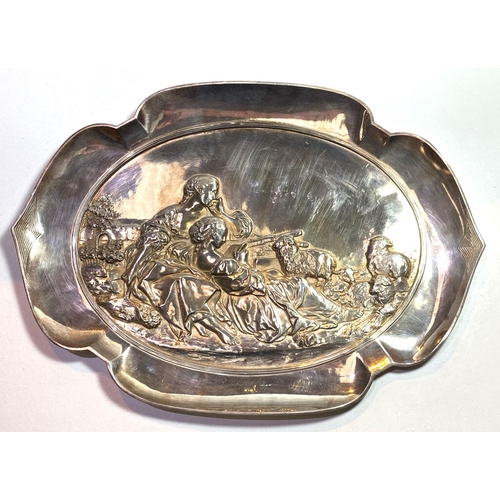 748 - An early 20th century WMF style dish with shaped border, decorated with shepherdess in relief, stamp... 