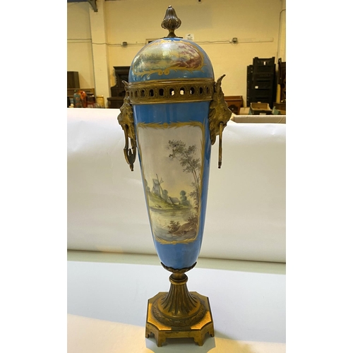 587 - A 19th century Sèvres covered vase with gilt interior and gilt animal head fittings, panel de... 