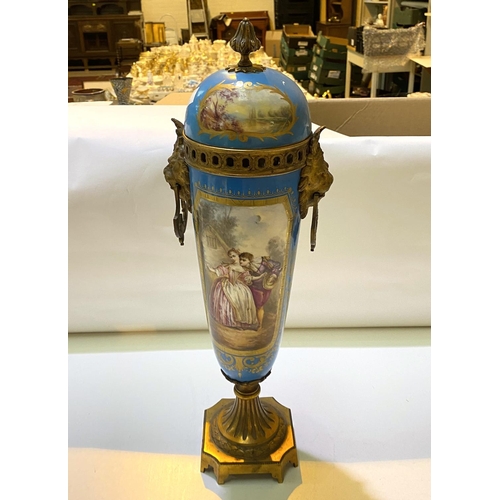 587 - A 19th century Sèvres covered vase with gilt interior and gilt animal head fittings, panel de... 