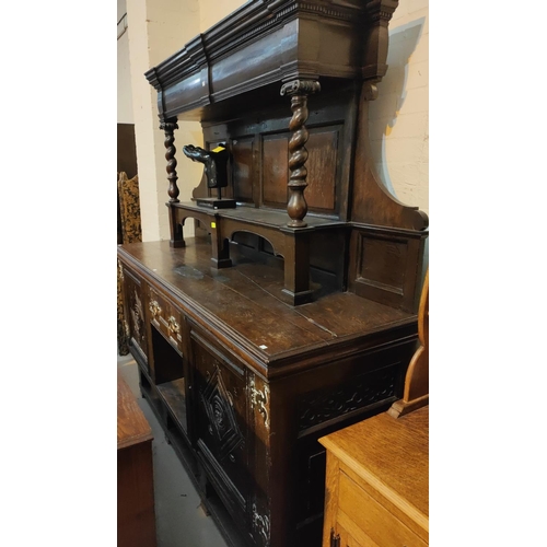 959 - A 19th century Jacobean style large dresser with raised panel back, 2 carved end cupboards, central ... 