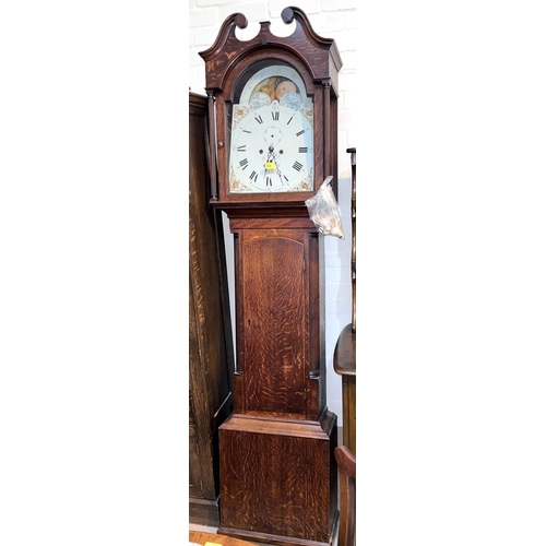 992 - An early 19th century oak longcase clock with swan neck pediment and reeded side columns to the hood... 