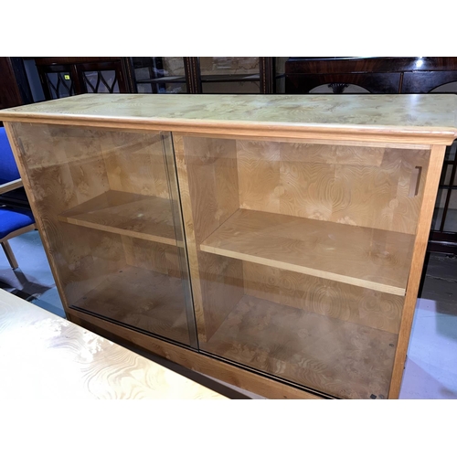 954 - A modern figured ash bookcase/display cabinet enclosed by glass doors