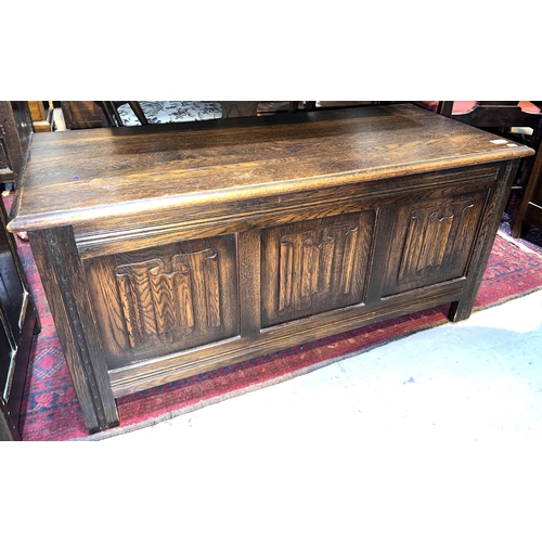 947A - A reproduction oak Priory blanket box having front panels with linen fold decoration