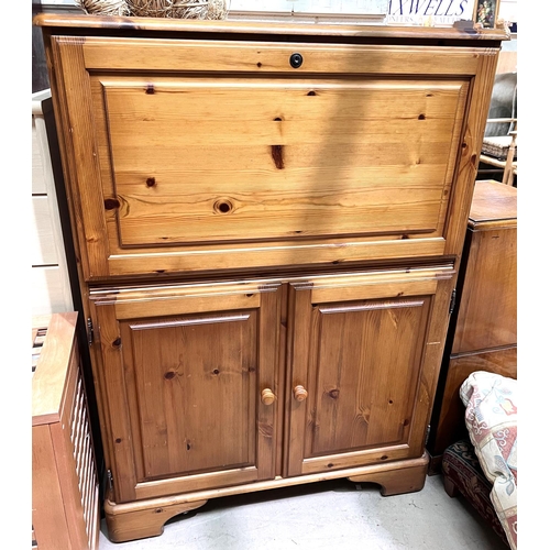 898 - A modern pine side cabinet with fall front upper section and double cupboard below