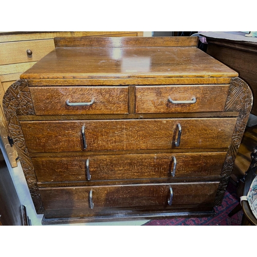 1023 - An Art Deco oak shaped chest of 3 long and 2 short drawers with chrome hooped handles, incised decor... 