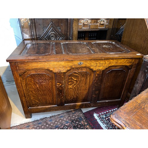 1027 - A golden oak panel front chest with hinged lid etc 115 x 55 x 69cm