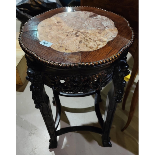 458 - A Chinese hardwood stand with lotus shaped marble top, carved decoration with pierced rim and dragon... 